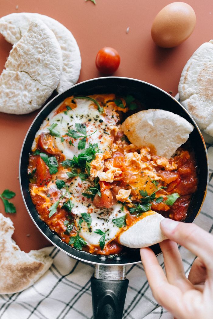 our-services-01 Savor a classic Shakshuka dish with vibrant tomatoes, eggs, and herbs served with fresh pita bread.