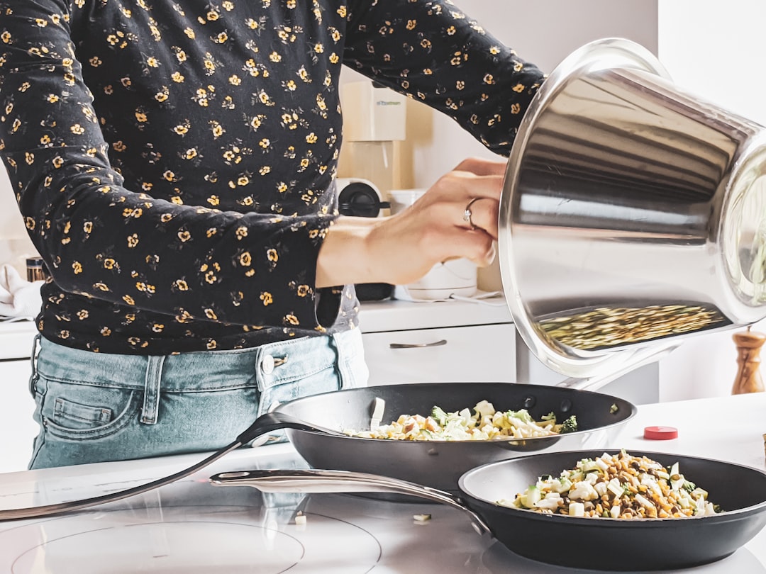 our-services-04 woman-in-black-and-white-polka-dot-shirt-and-blue-denim-jeans-holding-stainless-steel-cooking-iqp4kcvyefk